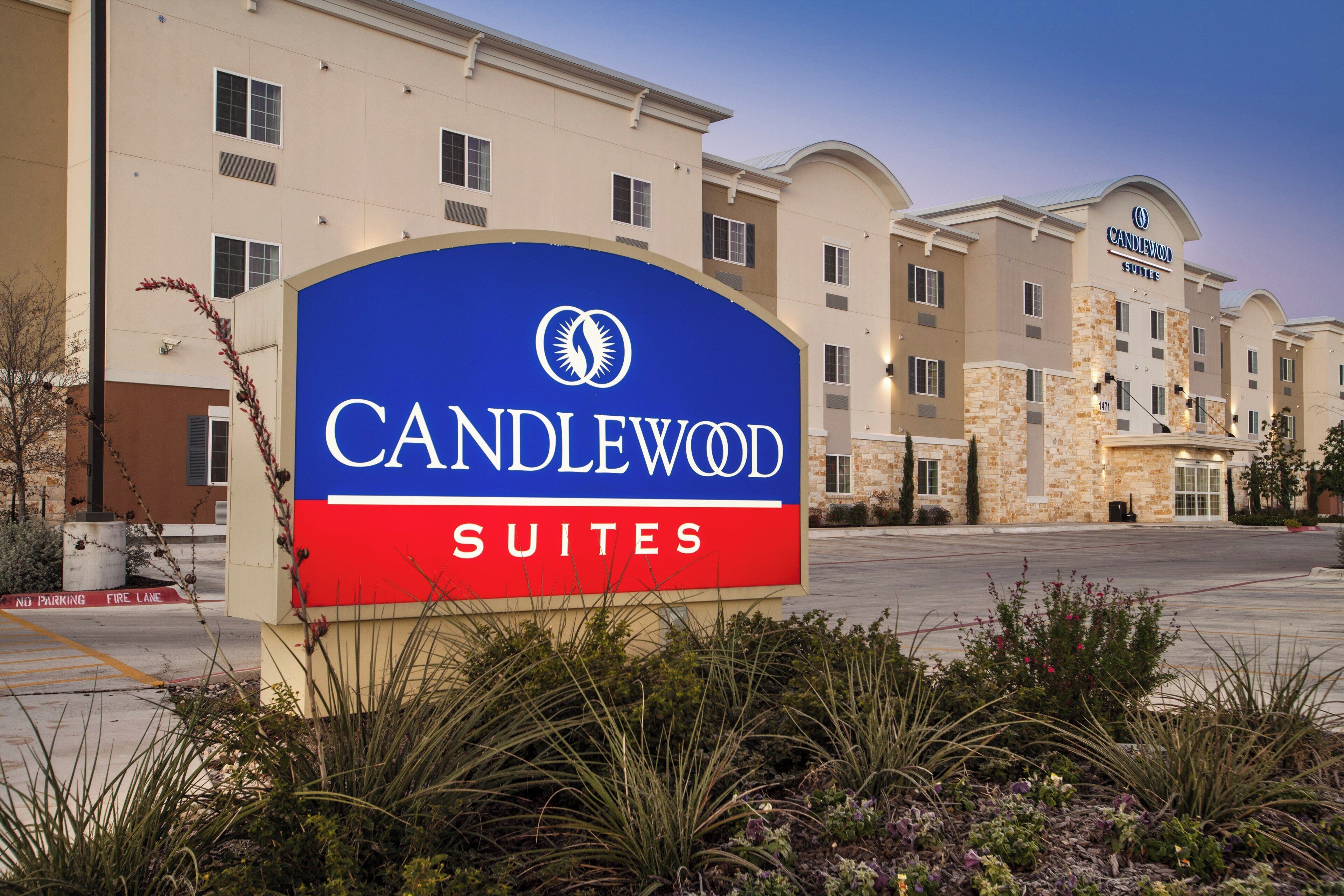 Une enseigne d’hôtel portant le nom « CANDLEWOOD SUITES » et un logo.