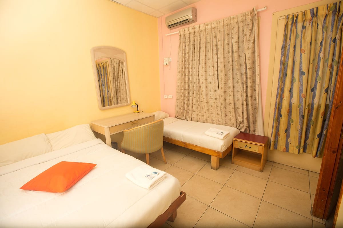 Triple Room, Private Bathroom (A/C) | In-room safe, bed sheets
