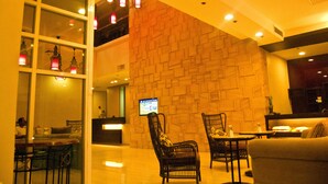 A lobby with a reception desk, seating area, and a staircase. - El Cielito Hotel - Sta. Rosa (Santa Rosa)