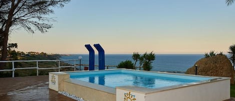 2 outdoor pools, open 10:00 AM to 7:00 PM, pool umbrellas, pool loungers