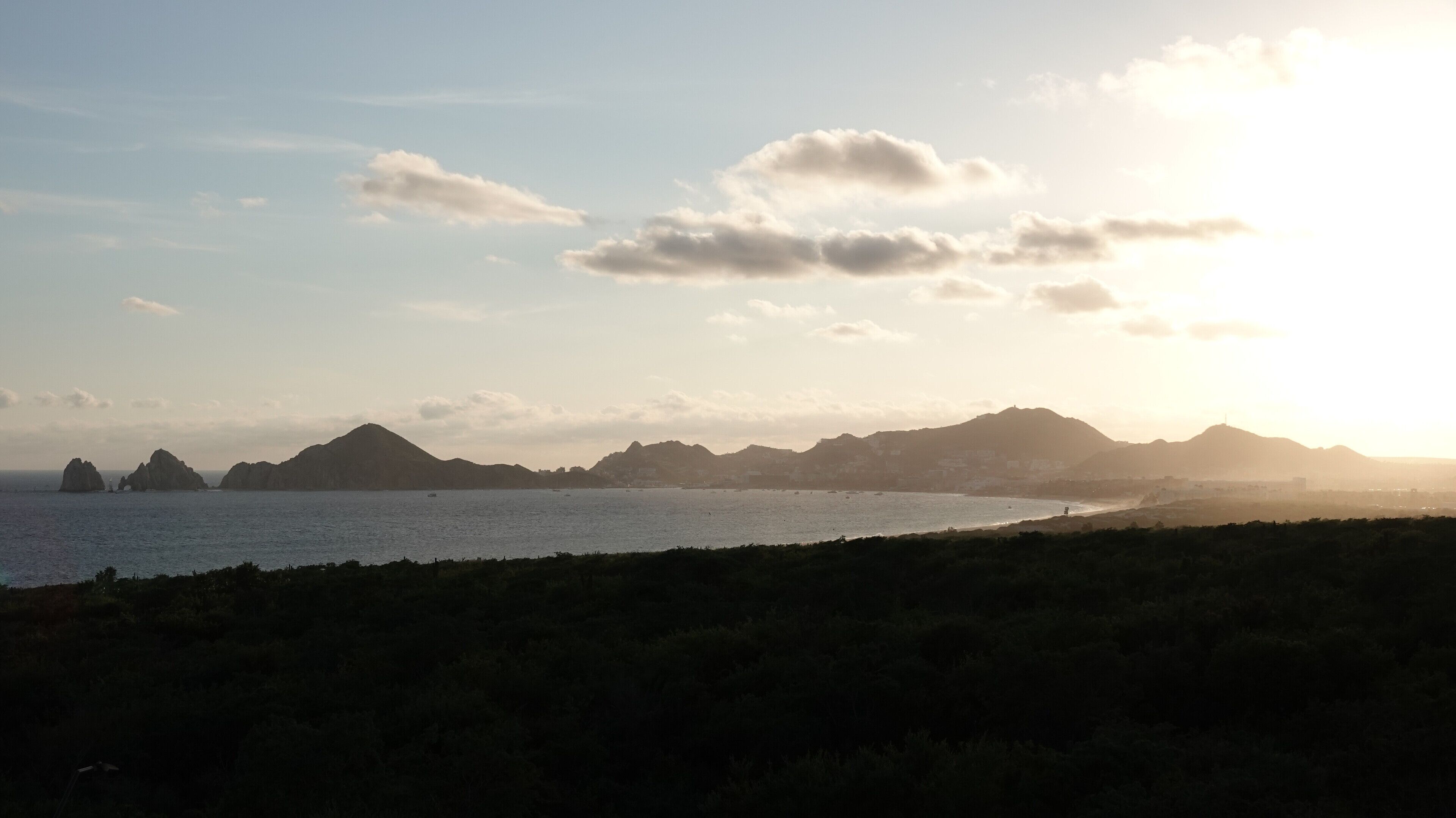 A coastal landscape with mountains and a body of water.