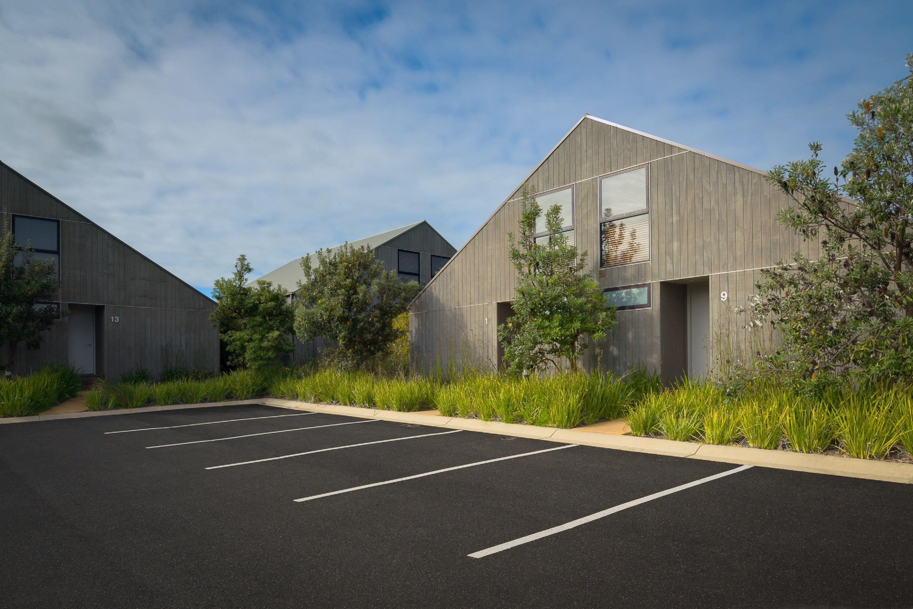 A modern building with a parking lot.