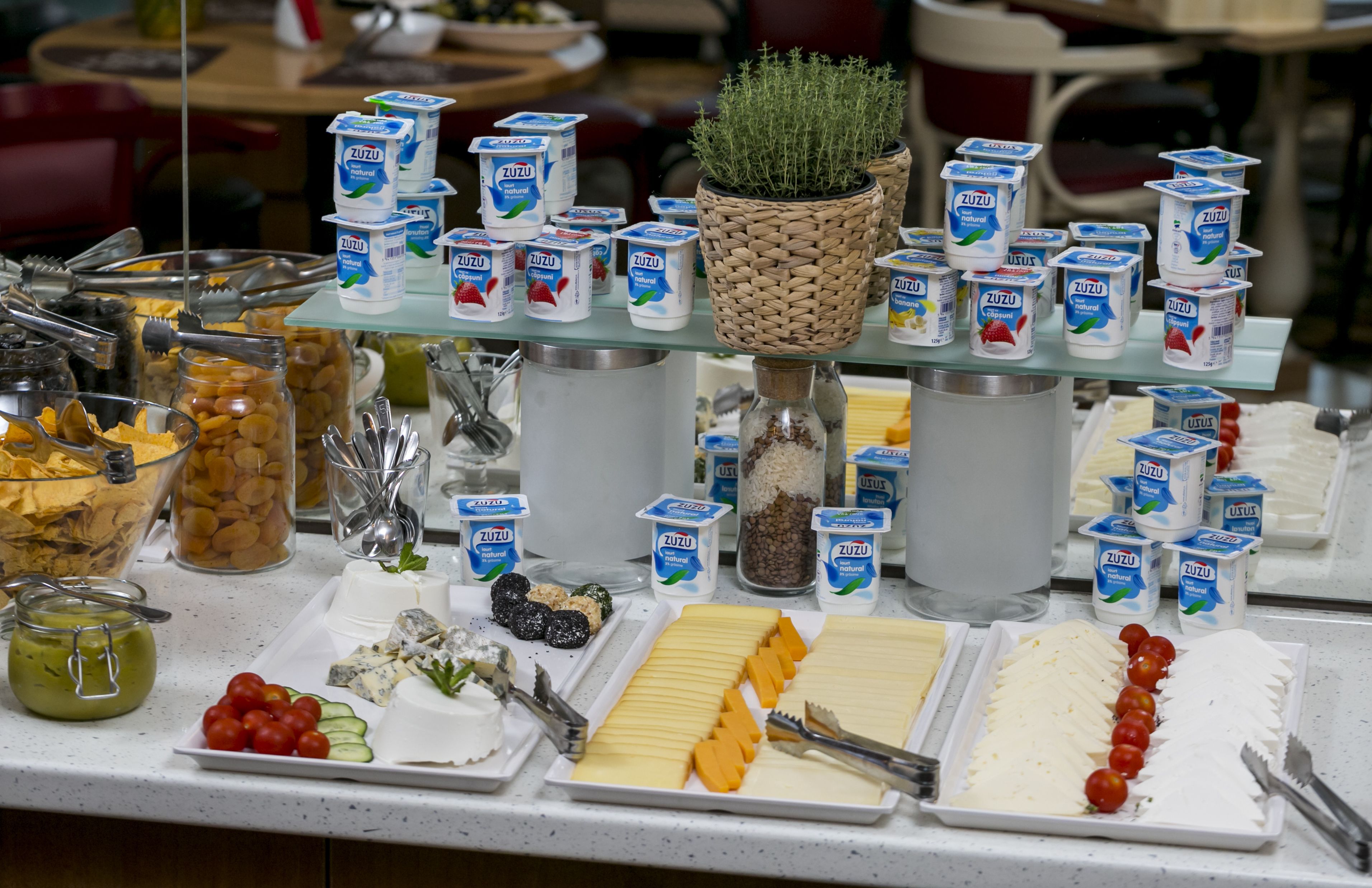 A buffet table with various food items and dairy products.