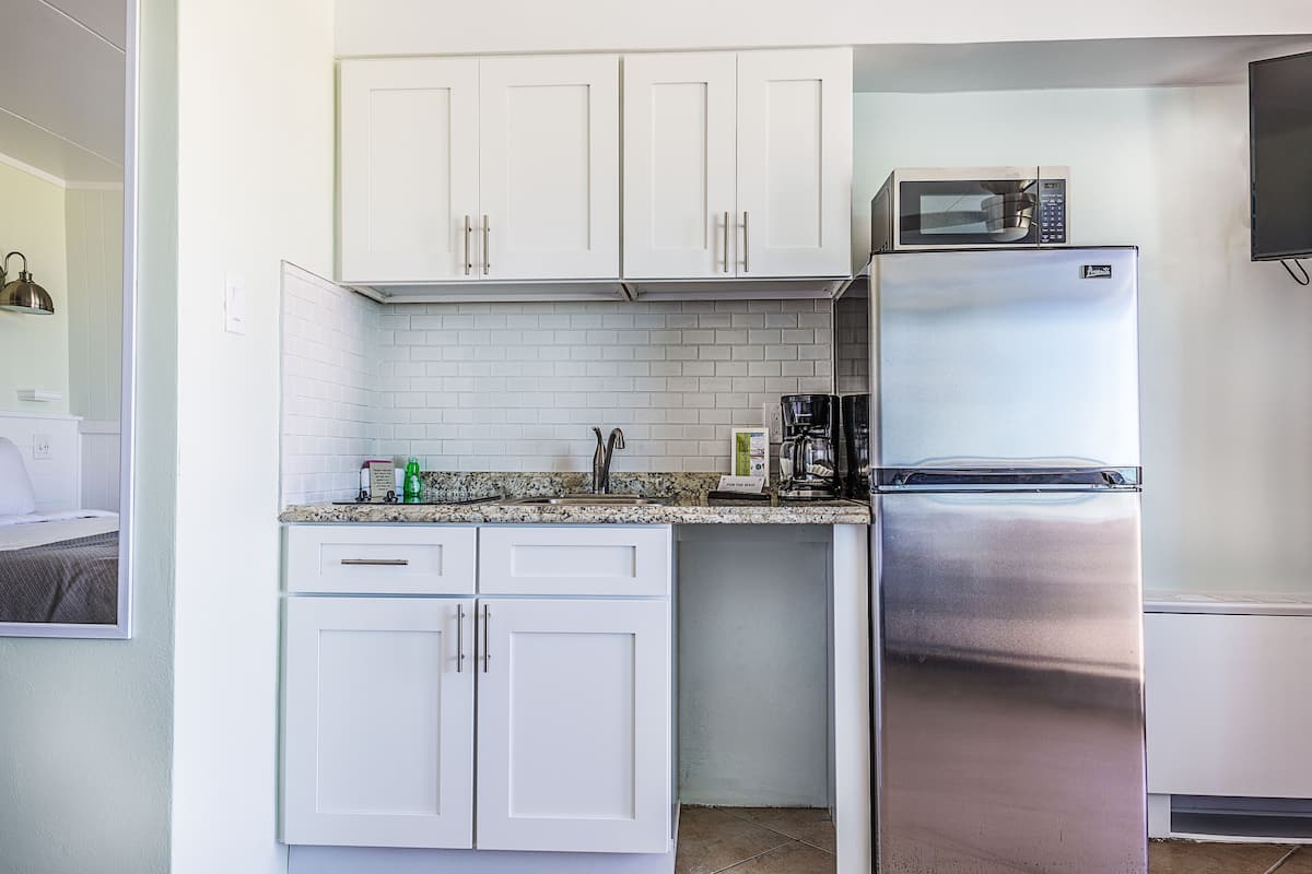 basic studio, 1 king bed with sofa bed, kitchenette | private kitchenette | fridge, microwave, coffee/tea maker