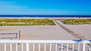 A beach volleyball court with a wooden pathway leading to the net. - Paradise Oceanfront Resort (Wildwood Crest)