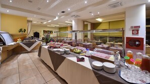 A buffet area with various food stations and a self-service beverage station.