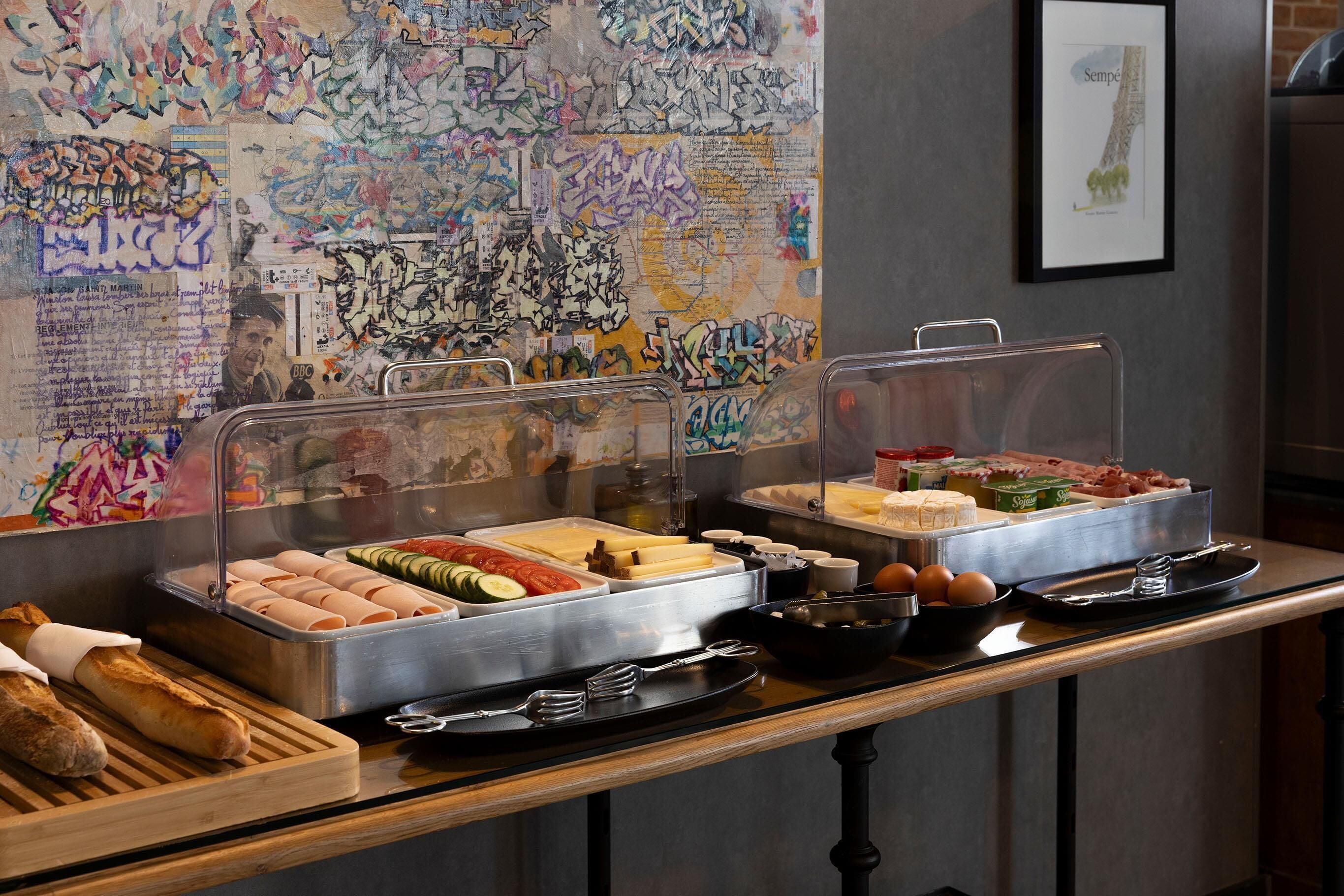 A buffet with various food items, including bread, eggs, and vegetables.