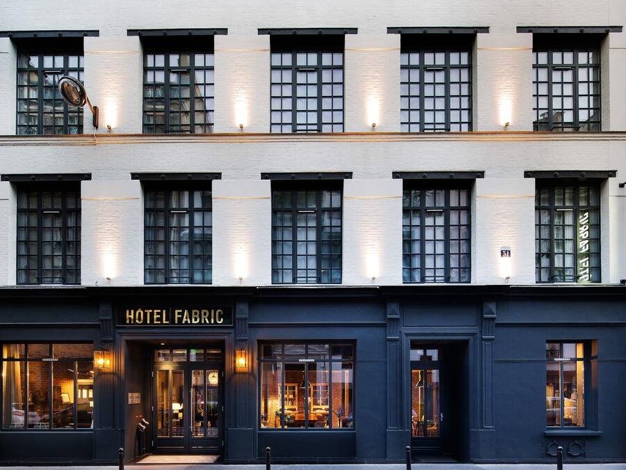 A two-story building with a sign reading "HOTEL FABRIC."
