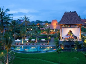 A resort with a swimming pool, lounge chairs, and a covered dining area. - Alaya Resort Ubud (Ubud)