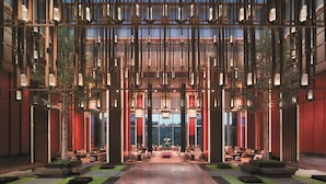 A spacious lobby with a central seating area, large windows, and a modern architectural design. - Shangri-La Qufu (Jining)