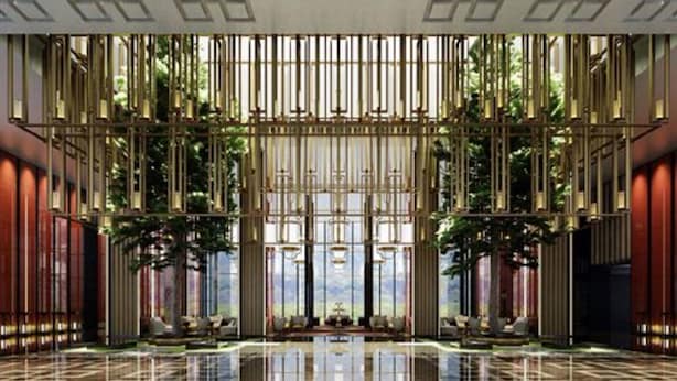 A spacious lobby with a high ceiling, vertical light fixtures, and a reflective floor. - Shangri-La Qufu (Jining)