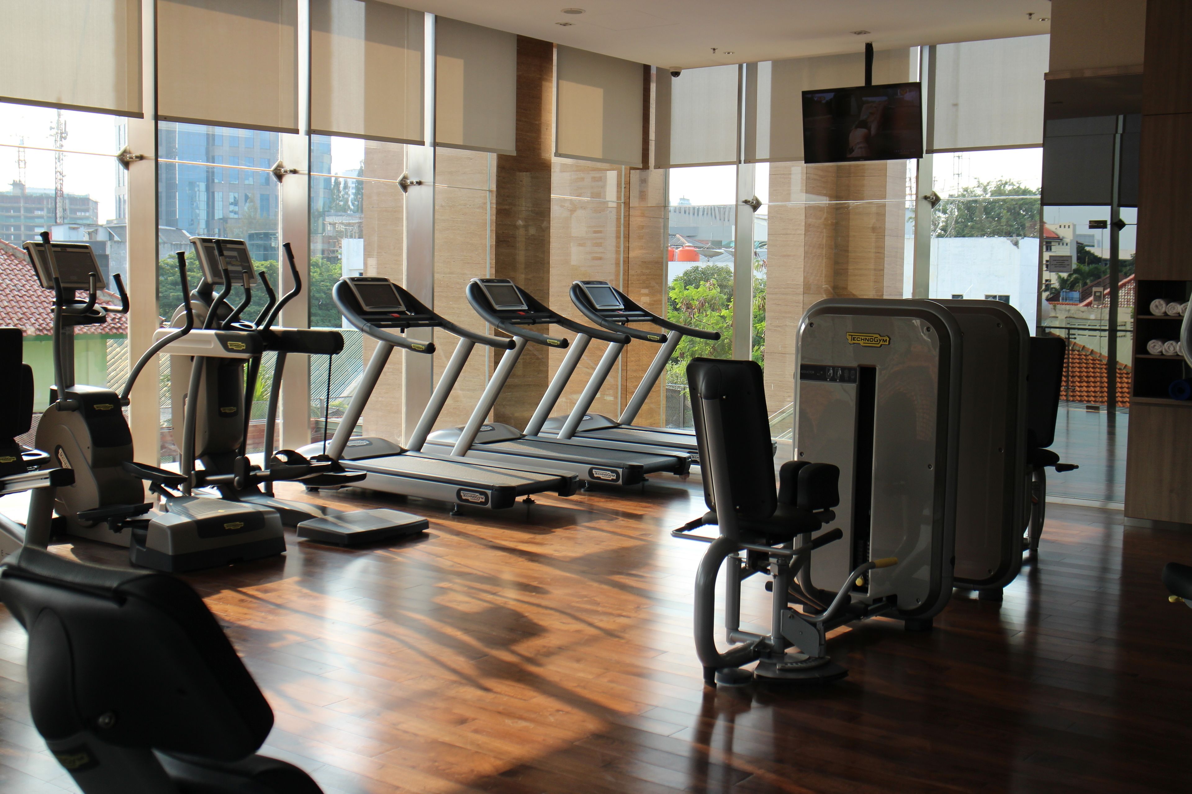 A gym with treadmills, elliptical machines, and weight equipment.