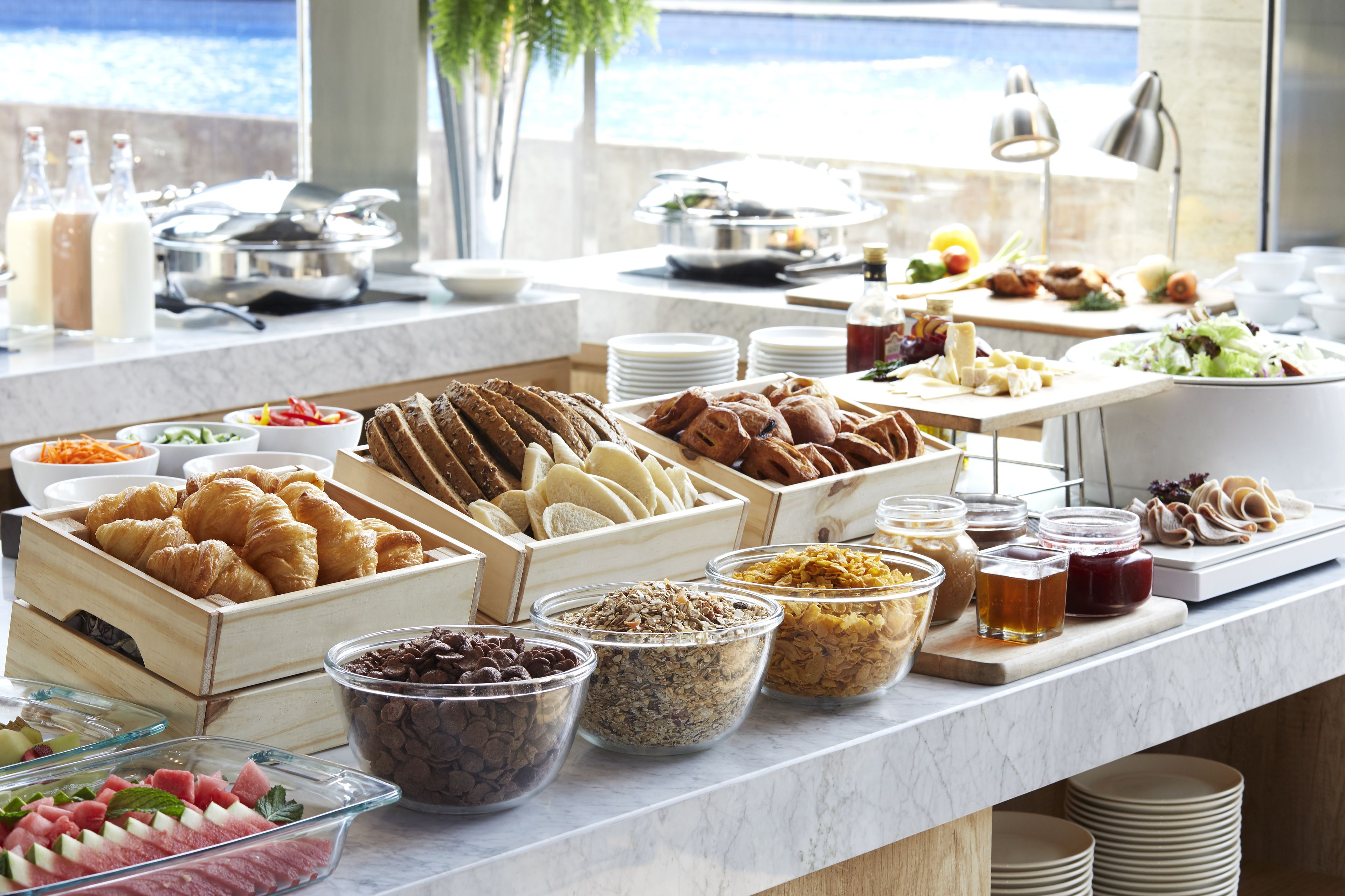Ein reichhaltiges Buffet mit verschiedenen Speisen, darunter Backwaren, Obst und Soßen.
