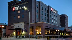 A Hilton Garden Inn hotel with multiple floors, large windows, and a well-lit entrance. - Hilton Garden Inn Lincoln Downtown/Haymarket (Lincoln)