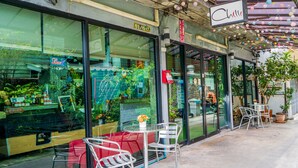 A cafe with outdoor seating, a glass storefront, and a sign reading "Chill". - The Chilli Bangkok (Bangkok)