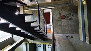 A construction site with exposed steel beams, a concrete floor, and a door marked "207". - The Chilli Bangkok (Bangkok)