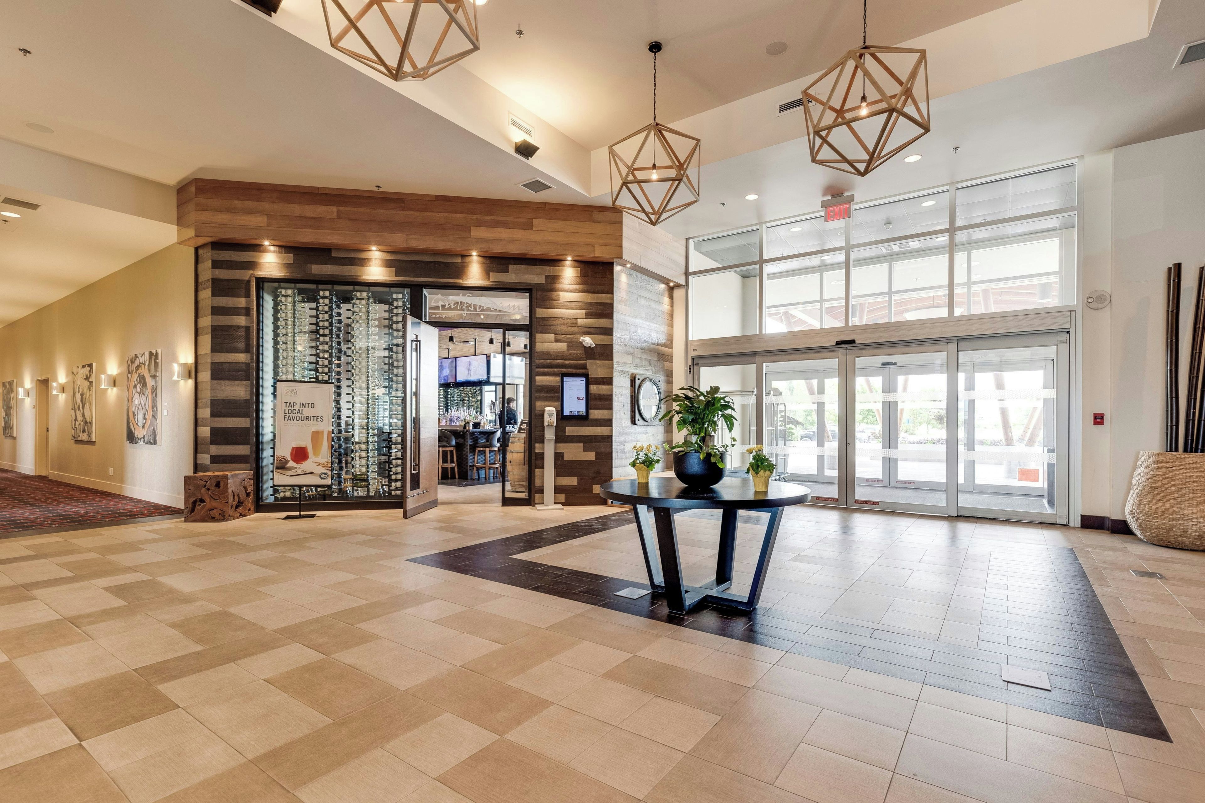 A spacious lobby with a checkered floor, a reception desk, and a bar area.
