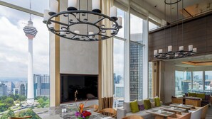 A modern kitchen with a large island, bar stools, and a city view. - Lanson Place Bukit Ceylon (Kuala Lumpur)