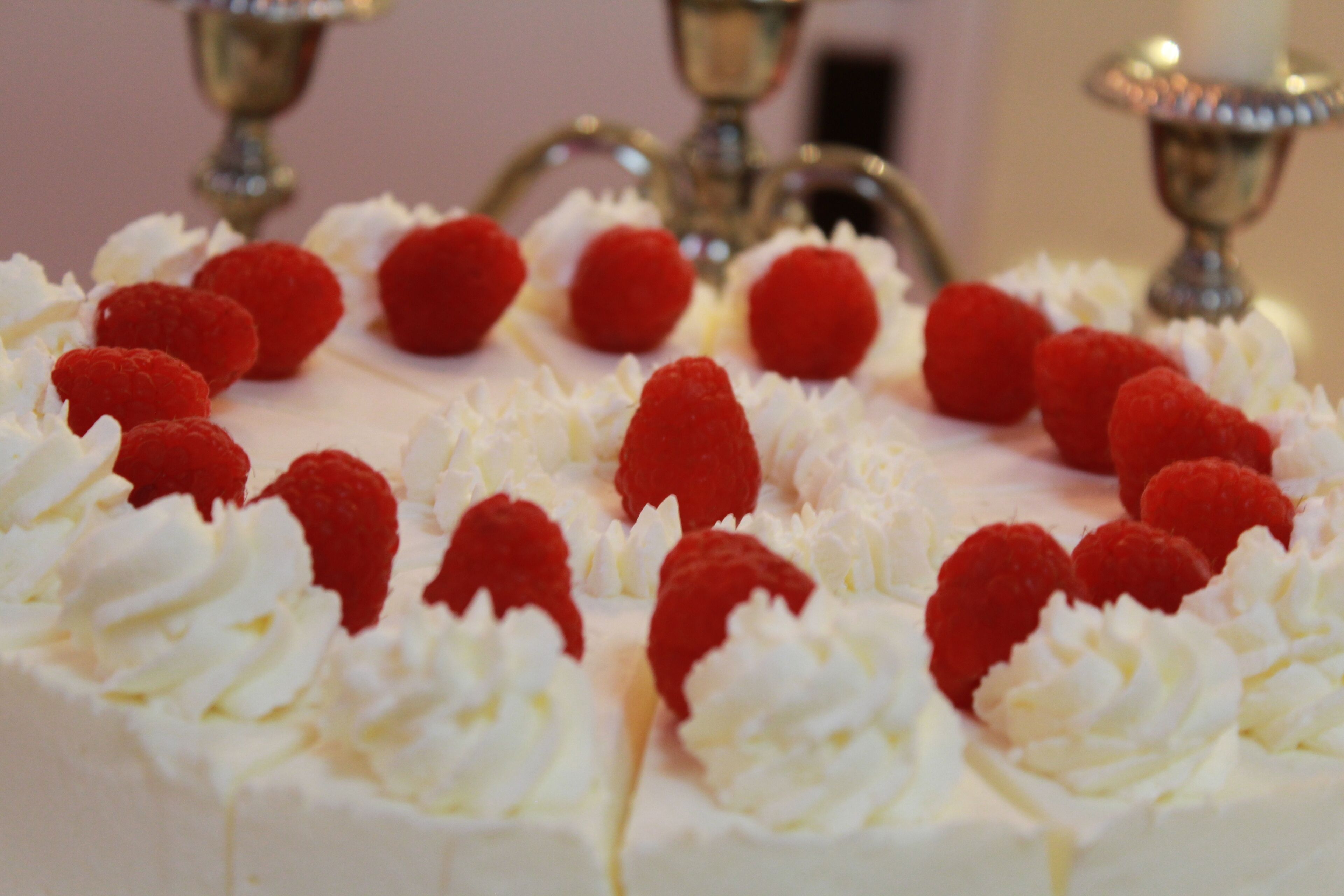 A dessert with cream and raspberries.