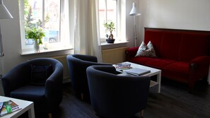 Relax in this stylish living room with a sofa, armchairs, and a coffee table.