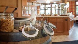 A buffet setup with various food items and utensils. - Badhotel Restaurant Stauferland (Bad Boll)