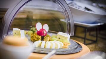 A dessert display with various sweets and a decorative item resembling a mouse.