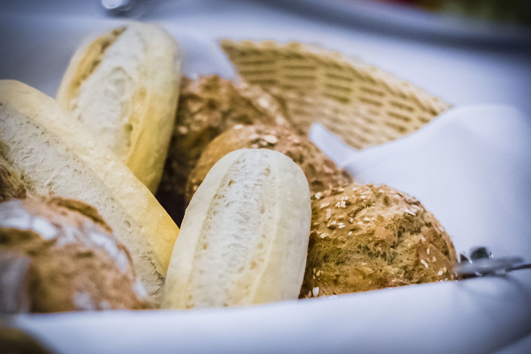 A variety of breads and crackers in a basket.