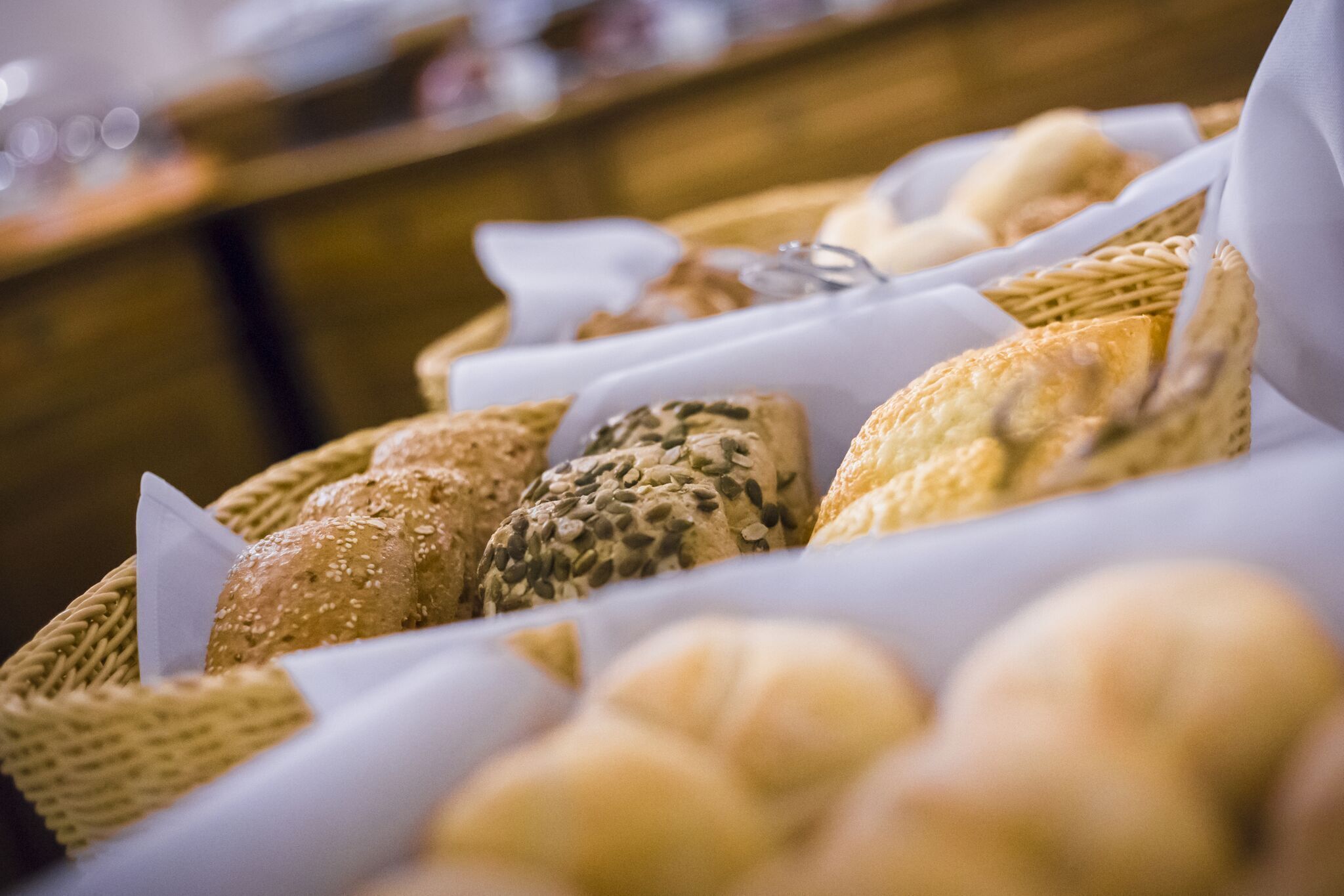A variety of breads displayed in baskets.