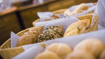 A variety of breads displayed in baskets.