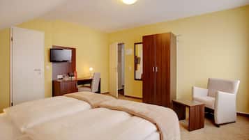 Relax in this serene space with a large bed, flat-screen TV, and comfortable seating area.