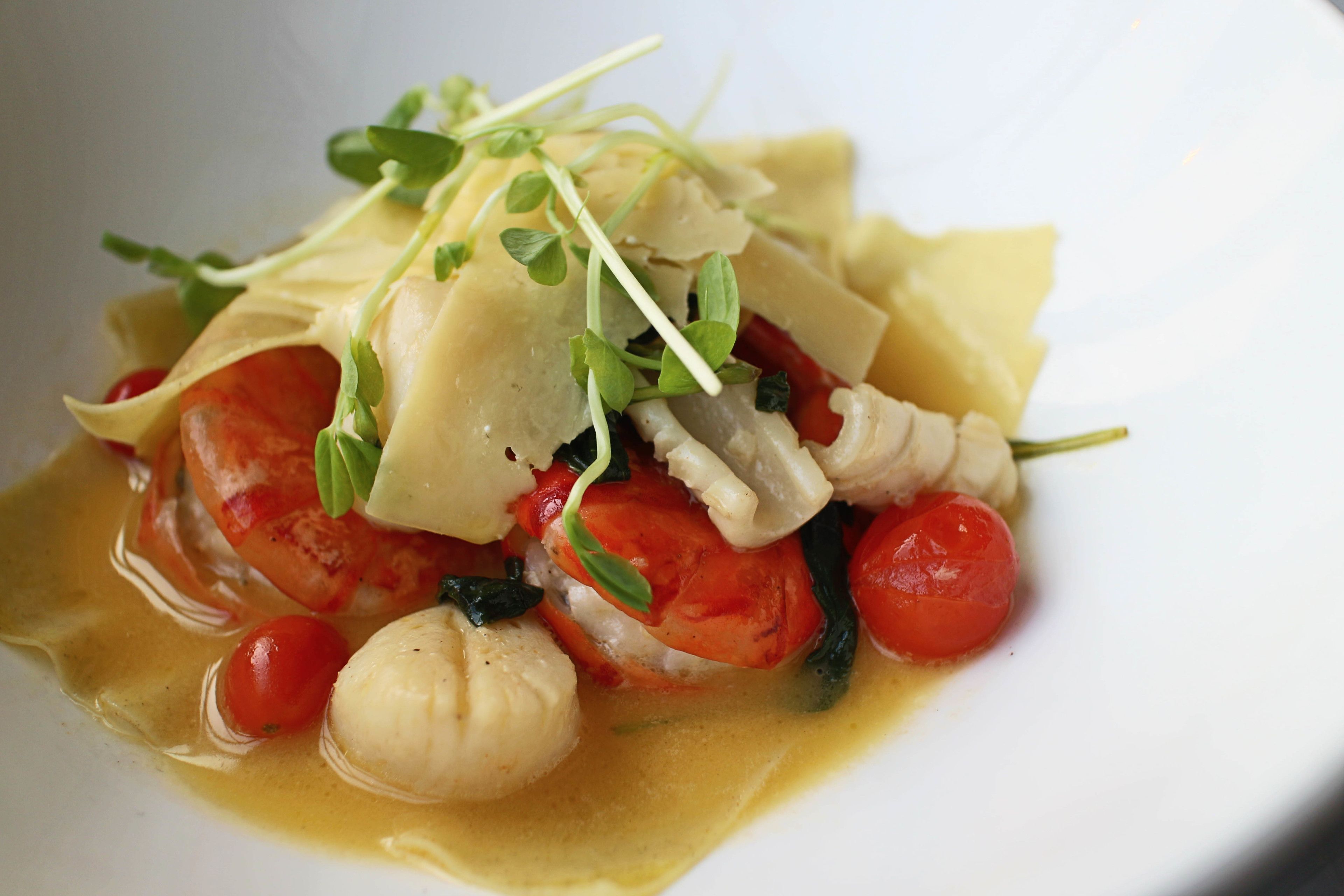 A dish with pasta, tomatoes, and a creamy sauce.