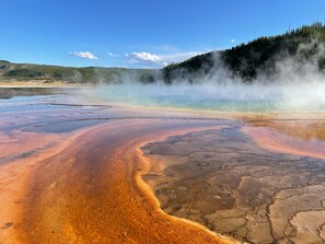 A geothermal area with mineral deposits and steam rising from the ground. - Holiday Inn Express Hotel & Suites Butte by IHG (Butte)