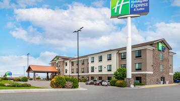 A Holiday Inn Express building with a prominent sign, a covered parking area, and a landscaped entrance.