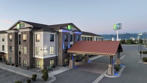 A Holiday Inn Express hotel with a stone facade, multiple windows, and a covered entrance. - Holiday Inn Express Hotel & Suites Belgrade by IHG (Belgrade)