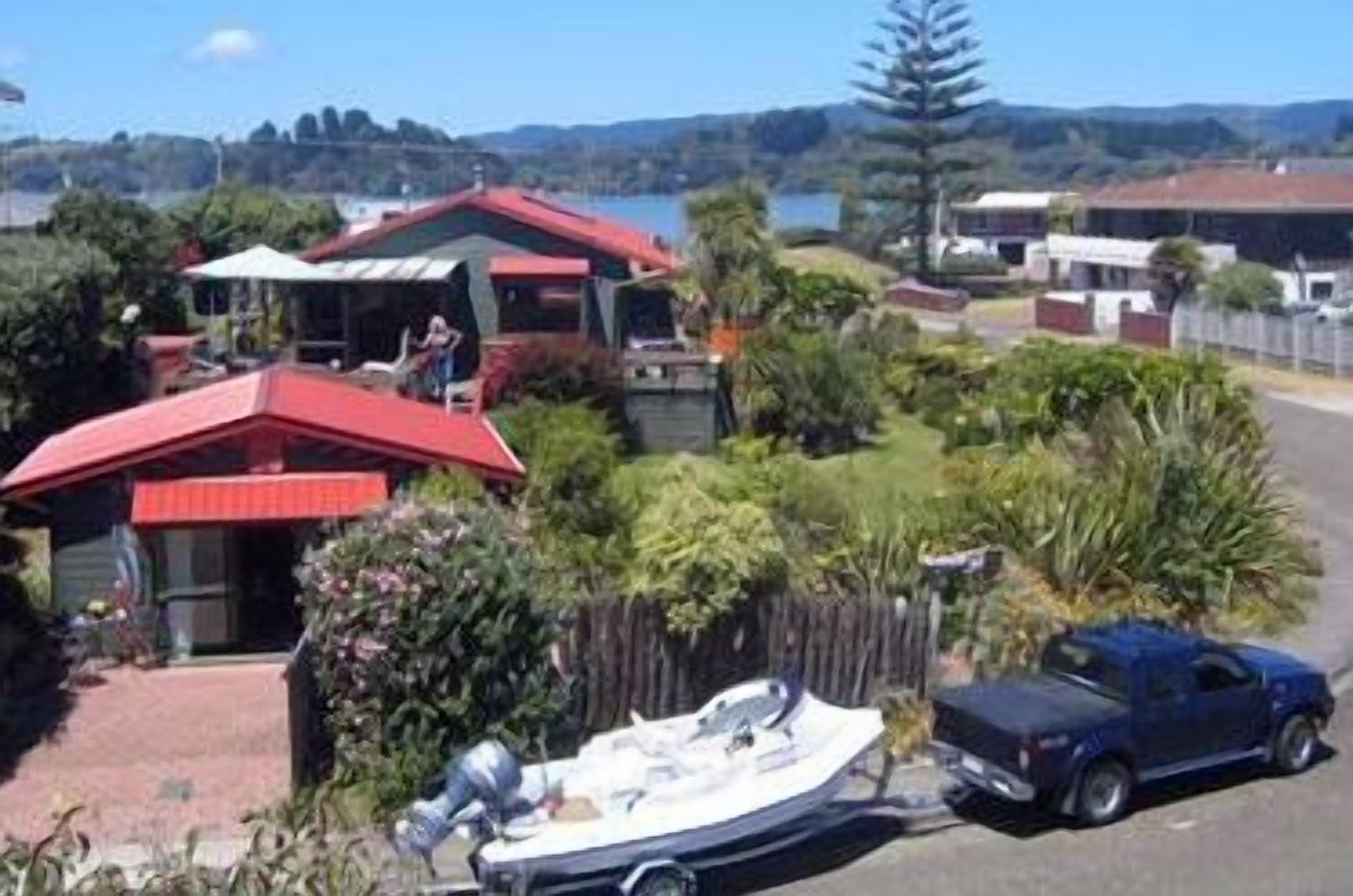 A residential area with houses, a boat, and a truck.