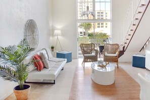 A spacious living area with a sofa, chairs, a coffee table, and a potted plant. - Coral Reef at Key Biscayne (Key Biscayne)