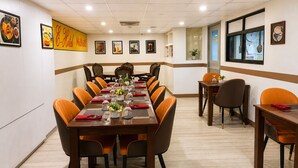 A conference room with a long table, chairs, and framed pictures on the walls. - The E-Hotel Makati (Makati)