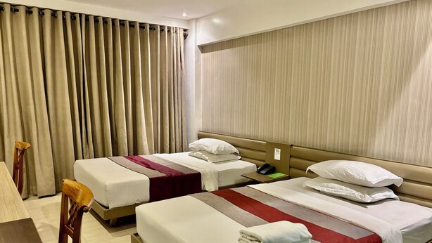 A hotel room with two beds, a desk, and a chair. - The E-Hotel Makati (Makati)