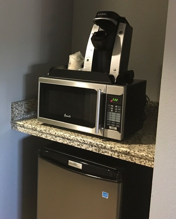 A compact kitchen with a microwave and a dishwasher.