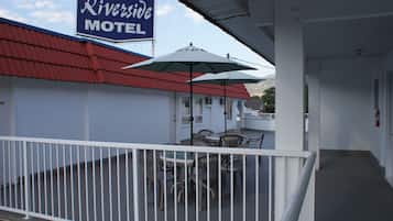 A Riverside Motel with outdoor seating and a covered patio area.