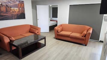Suíte executiva, 2 quartos | Sala de estar | TV de tela plana