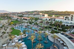 A resort with multiple buildings, a large central pool, and palm trees. - Secrets Puerto Los Cabos - Adults Only - All Inclusive (San José del Cabo)