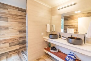 A modern bathroom with two sinks, wooden wall panels, and a large mirror. - Sea Dragon Kangaroo Island (Willoughby)