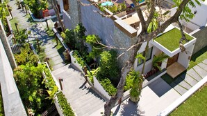 A residential area with modern architecture, including flat-roofed buildings and a well-maintained garden.