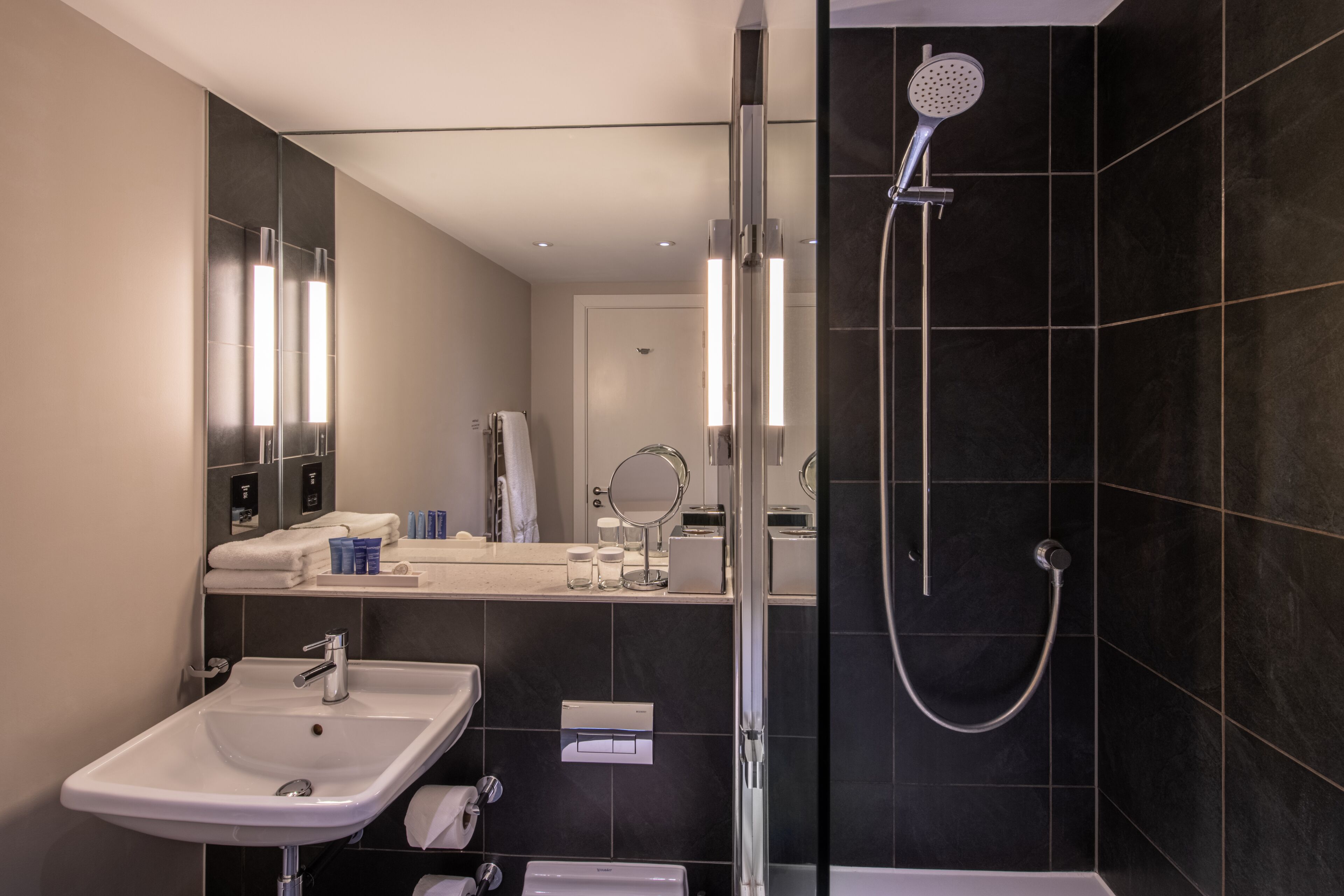 shower, designer toiletries, hair dryer, towels