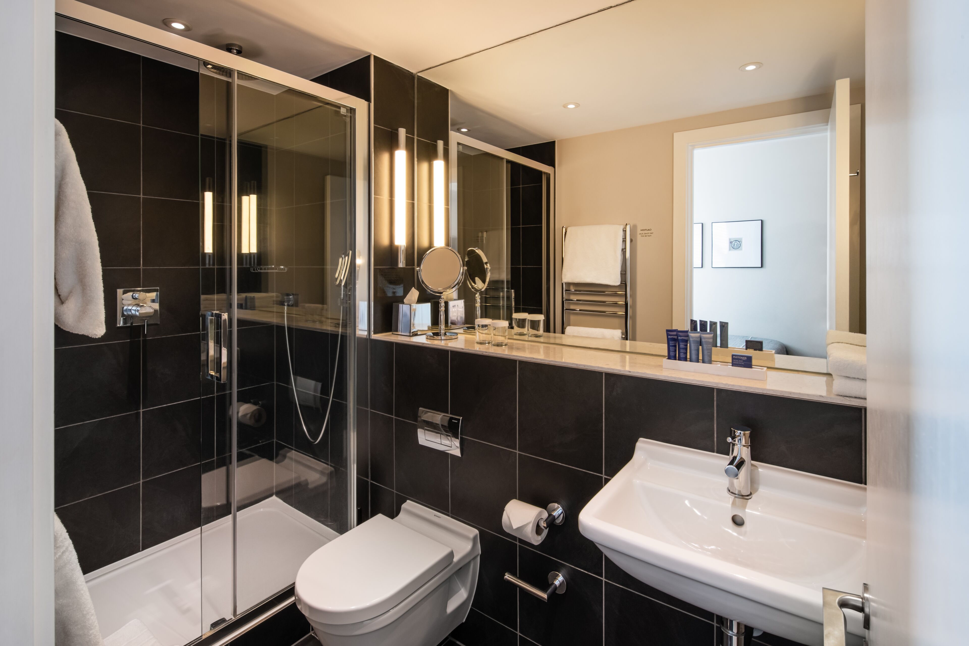 shower, designer toiletries, hair dryer, towels