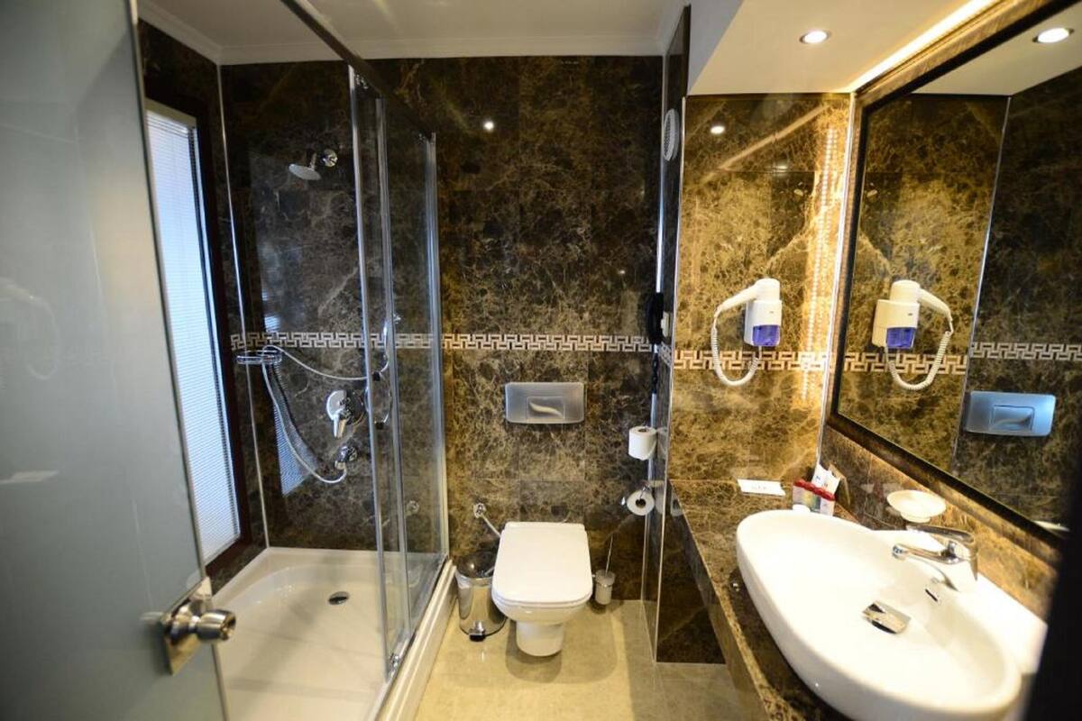 bathtub, hair dryer, slippers, towels