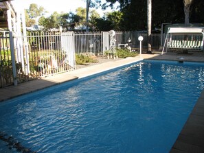 Outdoor pool, open 6:00 AM to 9:30 PM, pool loungers