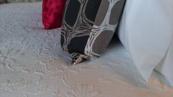 A close-up of a pillow with a geometric pattern and a textured fabric.