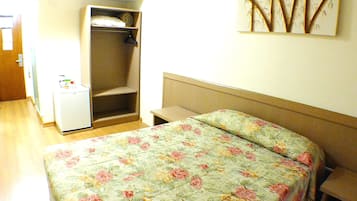 Cozy bedroom with a single bed, wardrobe, and small table.